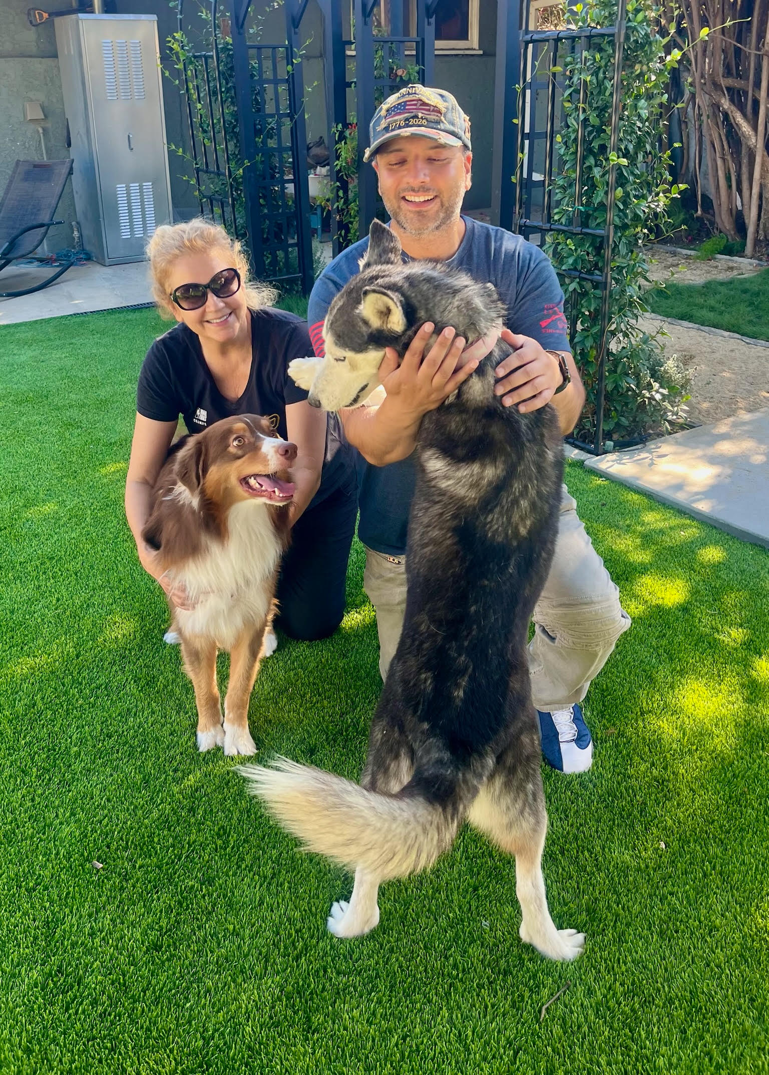 Susan and Barinder with Rock and Greta in their yard at home in Northridge on adoption day