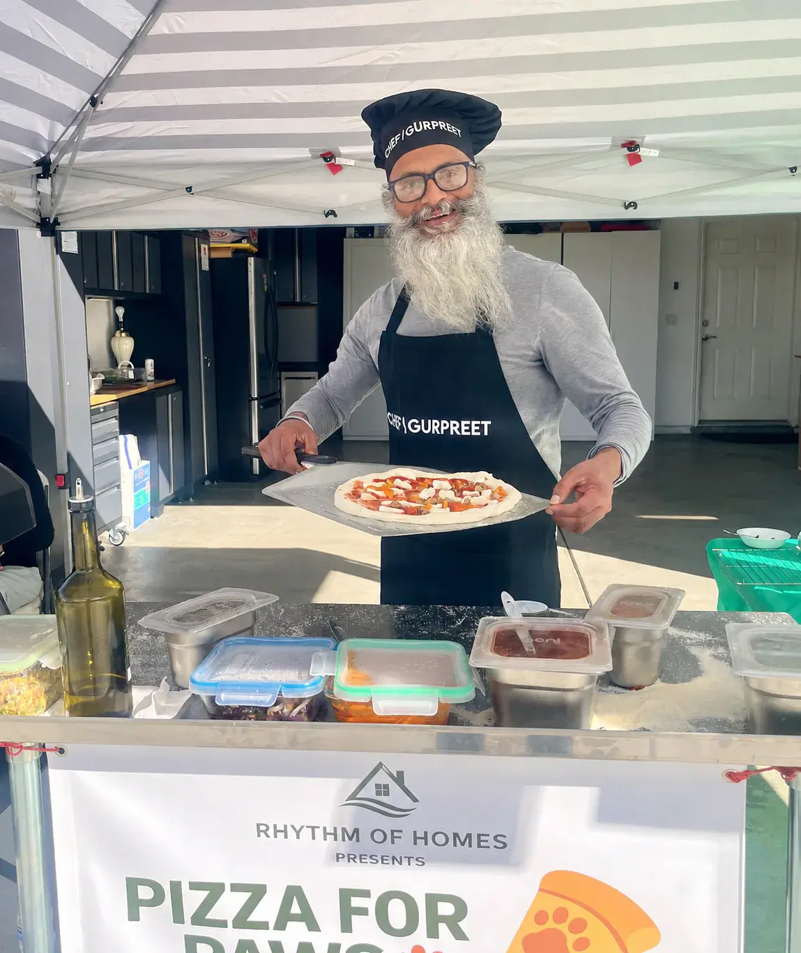 Gurpreet preparing a pizza during a Pizza for Paws event