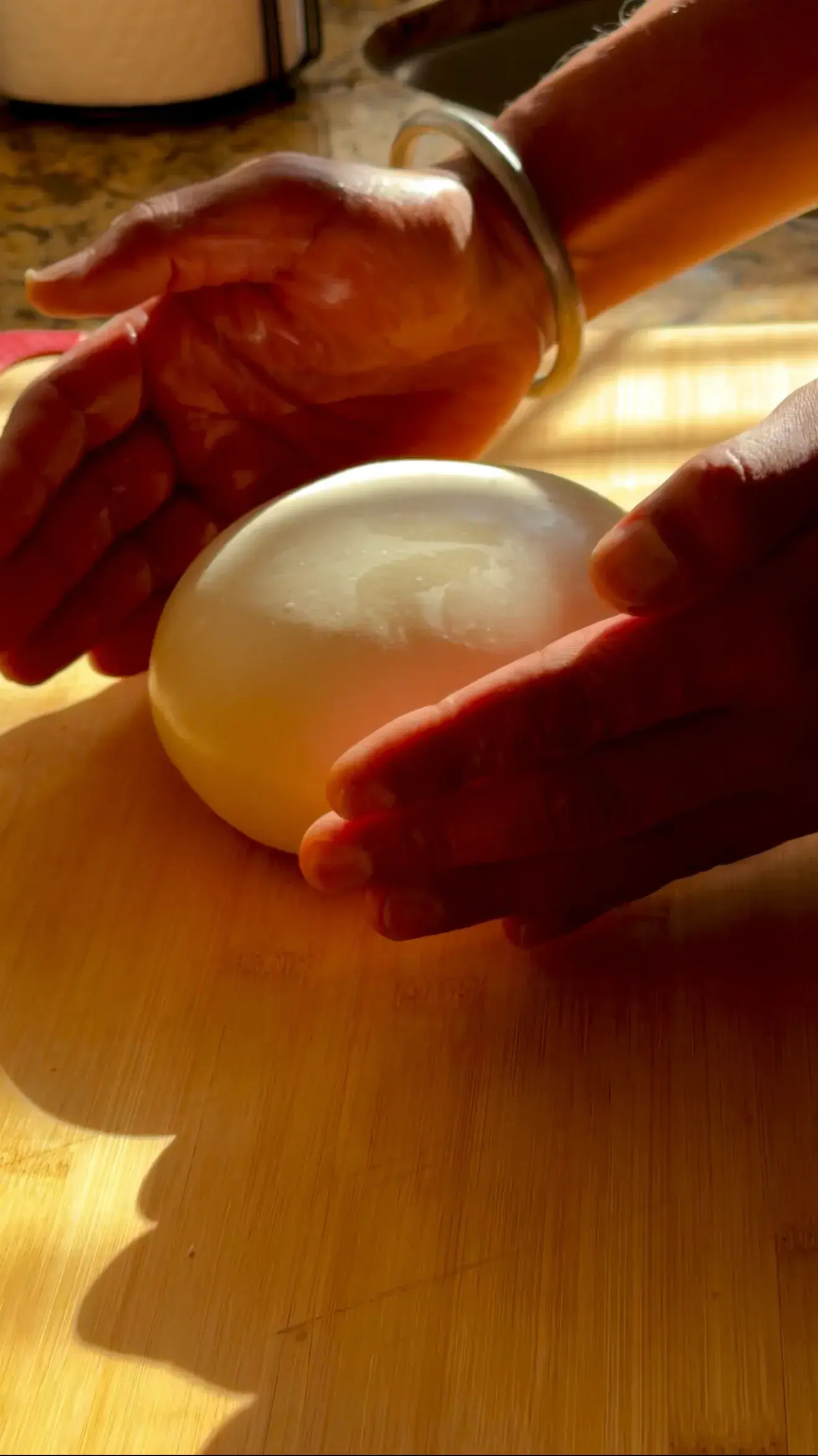 Gurpreet’s hands shaping a smooth pizza dough ball