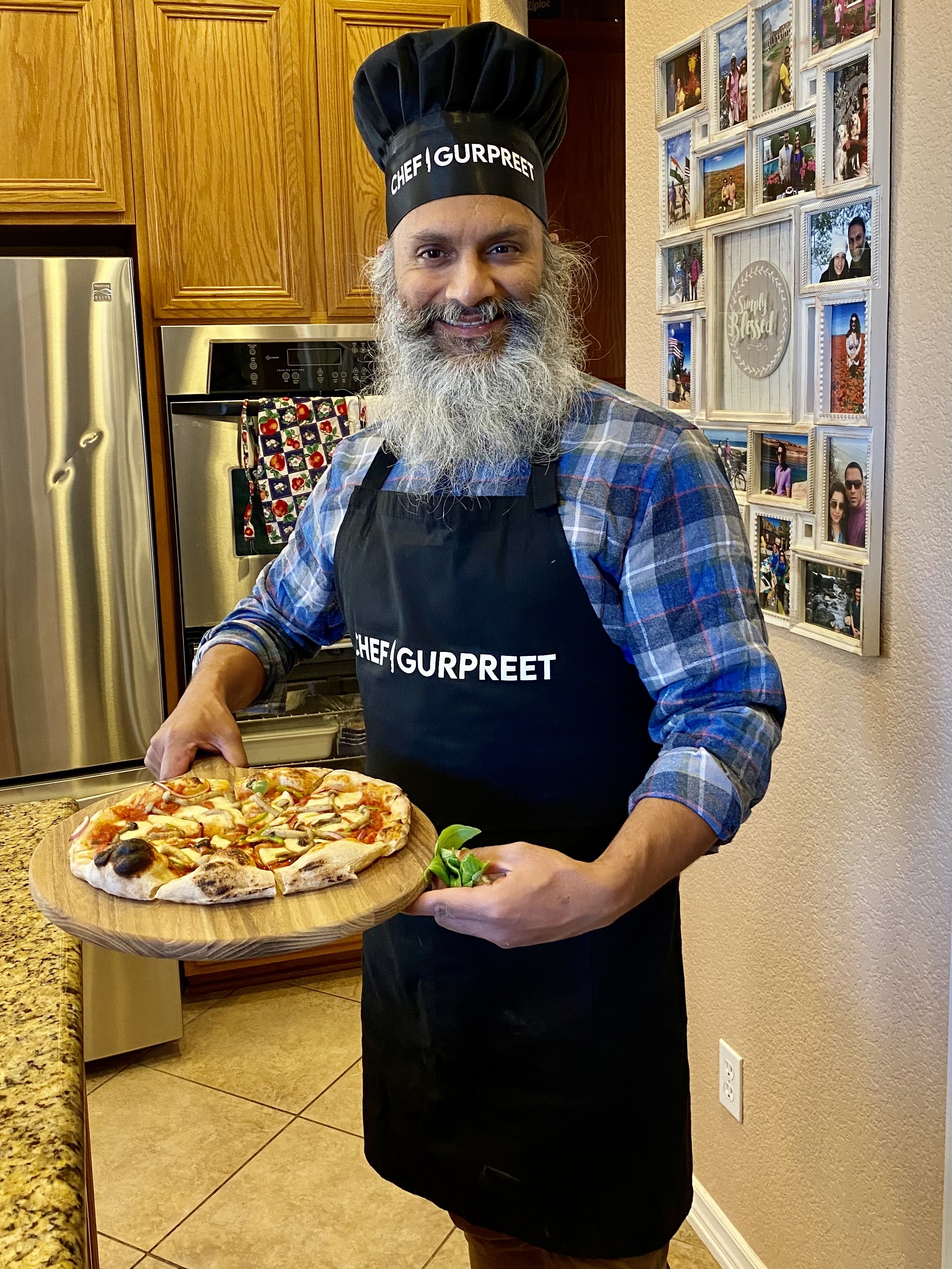 Gurpreet sharing a freshly made pizza in his home kitchen