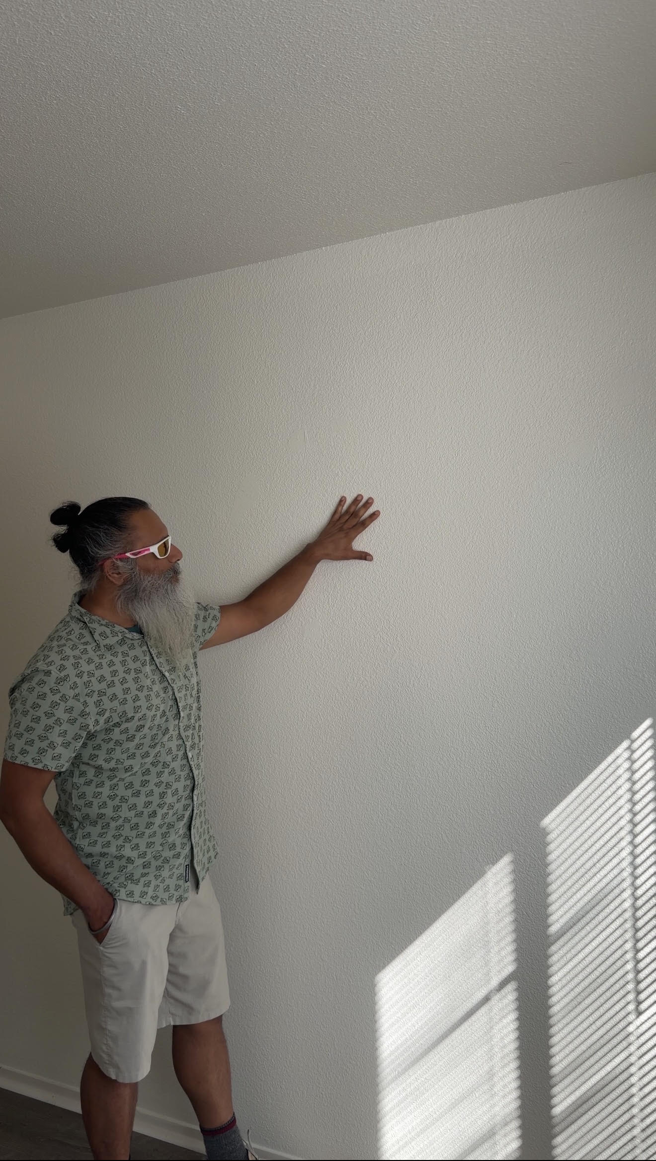Gurpreet inspecting the freshly painted wall in the Bakersfield rental